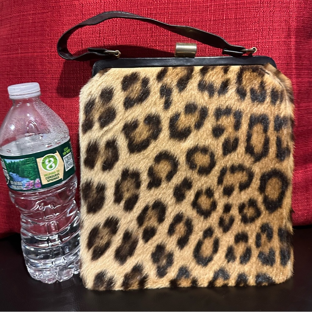 Pony hair small purse with leather strap.